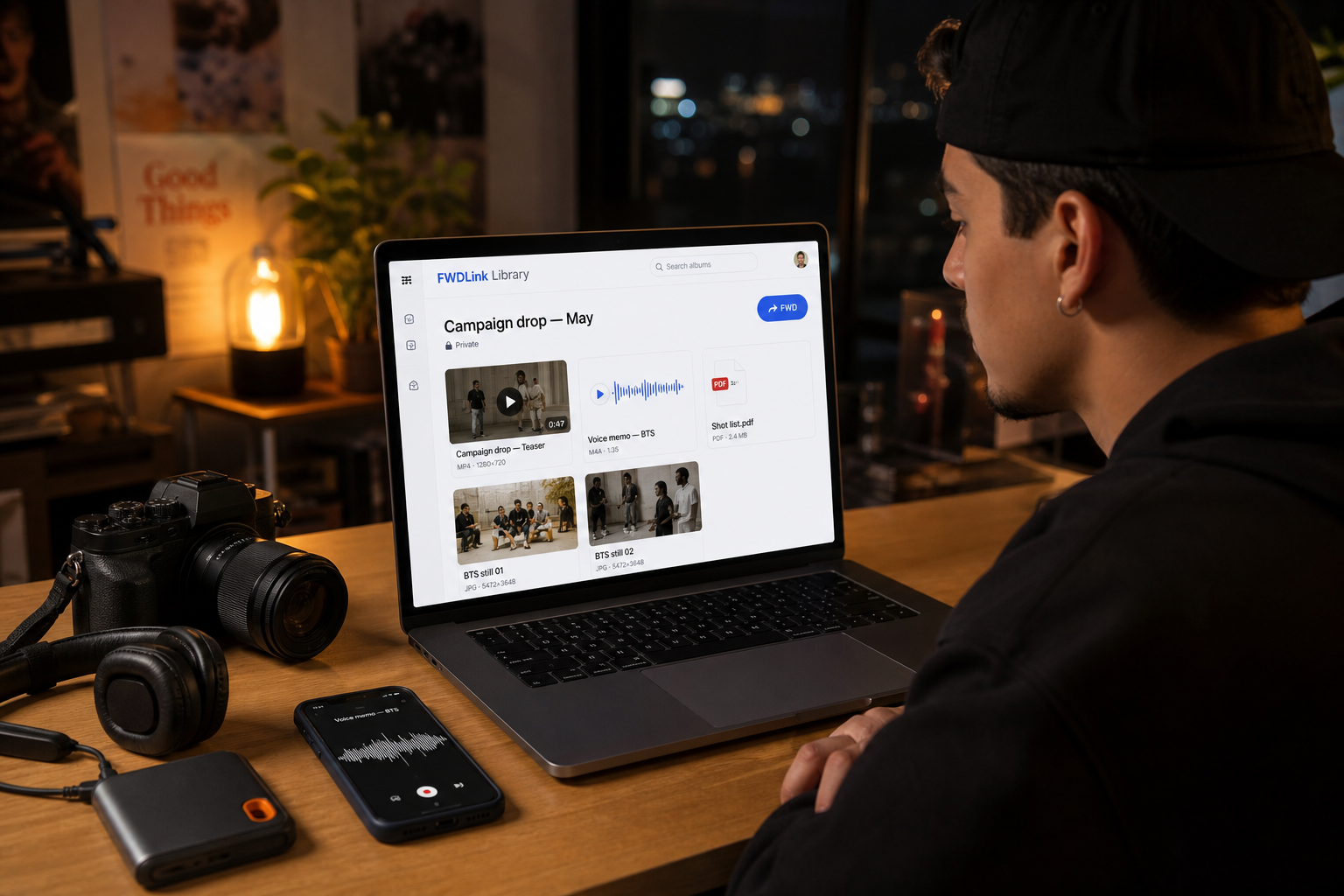 Creator at a desk with a private FWDLink library mixing video, a voice memo, a PDF, and BTS stills